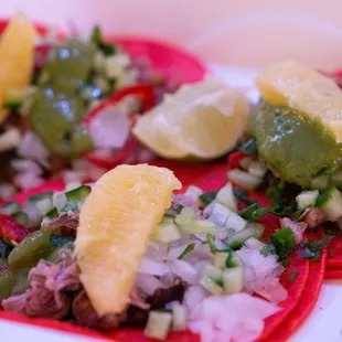 three tacos with various toppings