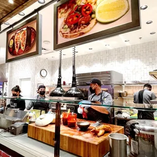 people in the kitchen preparing food