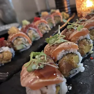 a sushi roll on a black plate
