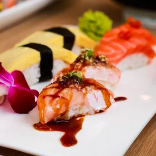 a variety of sushi on a white plate