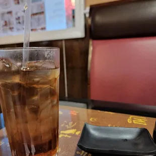 a glass of ice tea on a table