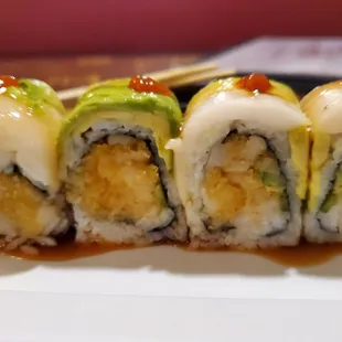 Falls River roll: spicy white tuna, crunch, jalapeno inside; white tuna, avocado outside with spicy sauce.