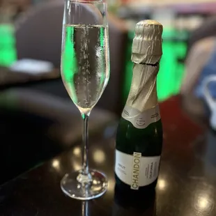 a glass of wine and a bottle of champagne