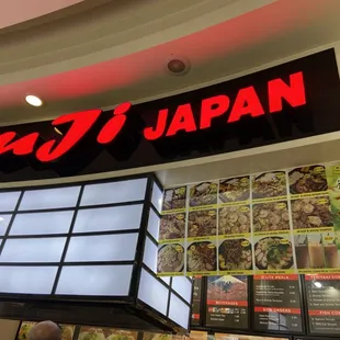 a restaurant with a neon sign above it