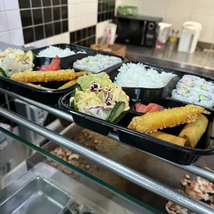 three trays of food on a counter