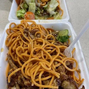 two takeout containers with noodles and meat
