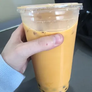 A picture of Thai tea with boba pearls. (2)