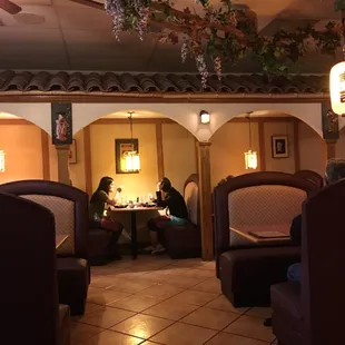 two people sitting at a table in a restaurant
