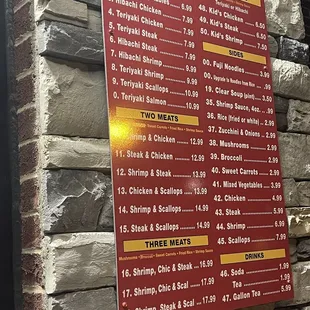 a menu on a brick wall