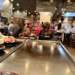 a man and a little girl sitting at a table