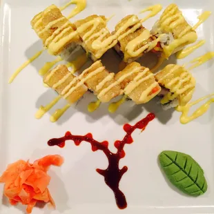 a plate of sushi with sauce