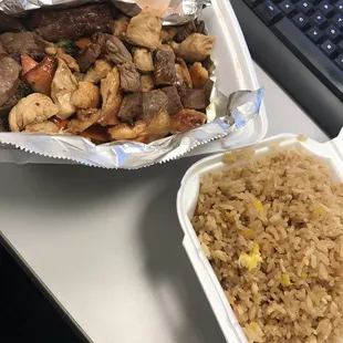 a tray of rice and a container of chicken