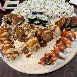 a plate of sushi and rolls