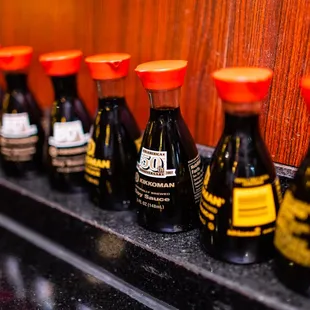 a row of bottles of sauce