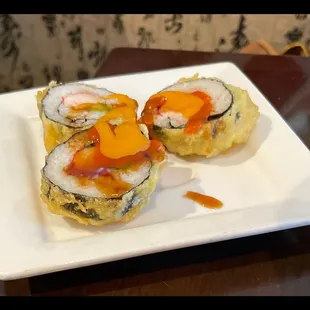 three pieces of sushi on a plate