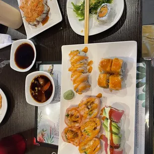 Volcano roll (top right) (#102) Seaweed salad (#91) and a piece (#49)  (#103) (#55) (#95) (#104)