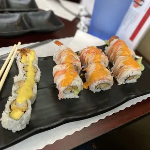 a plate of sushi and chopsticks