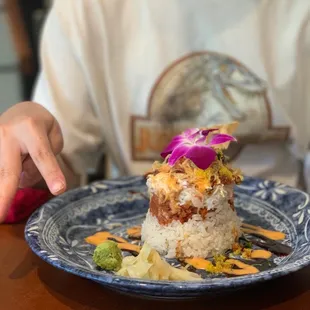 a person sitting at a table with a plate of food