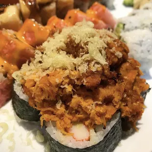 a plate of sushi and rolls