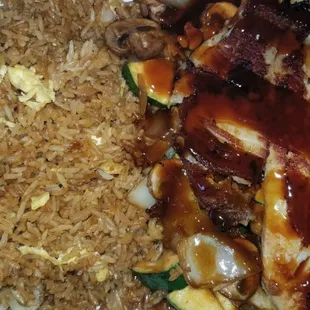 a plate of rice, meat and vegetables