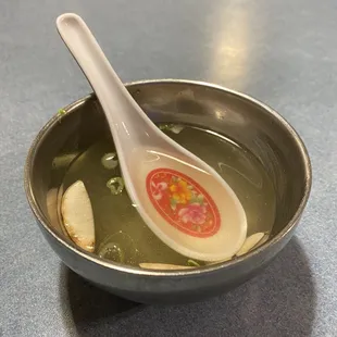 a bowl of soup with a spoon in it