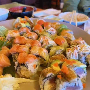 a plate of sushi with a side of salad