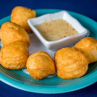 a plate of fried food with dipping sauce