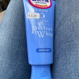 a blue tube of lotion on a person&apos;s lap
