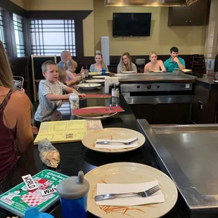 a group of people sitting at a table in a restaurant