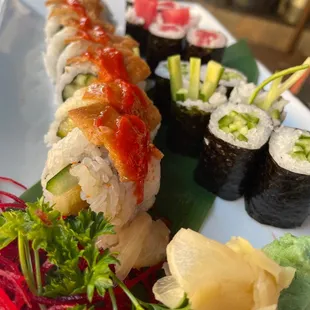 a plate of sushi and vegetables