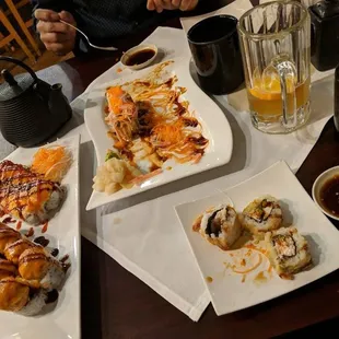 plates of sushi and rolls on a table