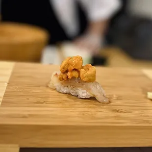 a sushi on a wooden cutting board