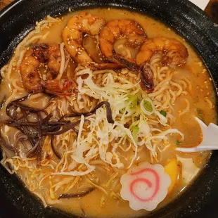 a bowl of ramen with shrimp and mushrooms