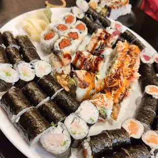 a plate of sushi and rolls