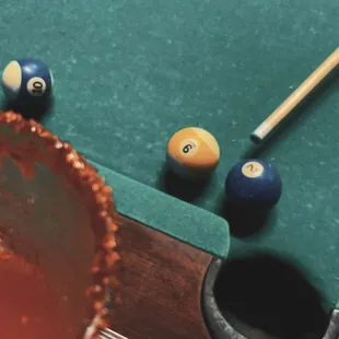 Pool table, pickle beer/Michelada and chamoy