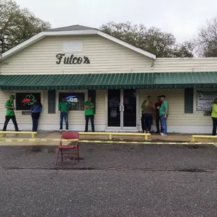 people standing outside of a building