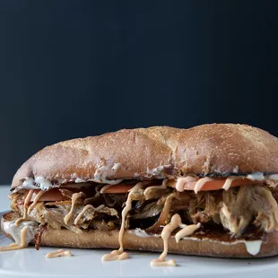 Sandwich Pernil

Bread stuffed wt Pork, tomato and spice Mayo