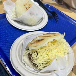 two plates of food on a tray