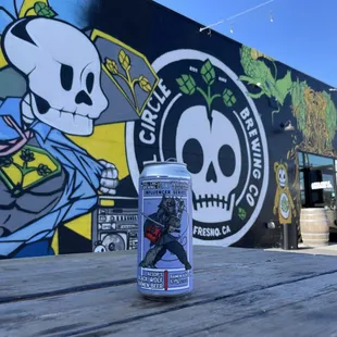 a can of beer sitting on a picnic table