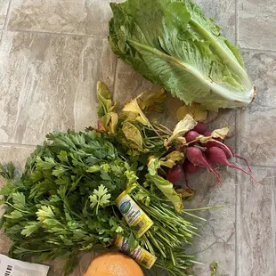 a variety of vegetables on a tile floor