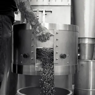 a man pouring grain into a bucket