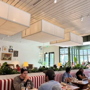 people sitting at tables in a restaurant