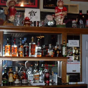a shelf full of liquor bottles