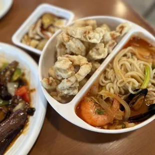 a bowl of noodles, shrimp, and vegetables