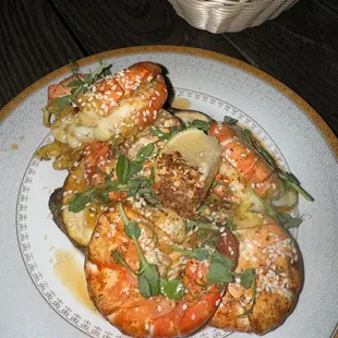 Jumbo shrimp.  There are sliced potato's under the shrimp.