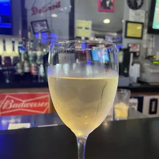 a glass of white wine on a napkin