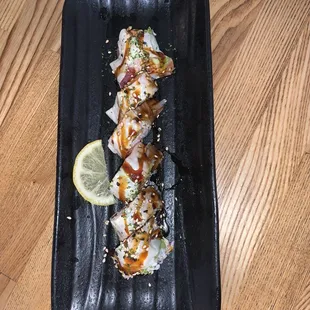 a plate of sushi on a wooden table