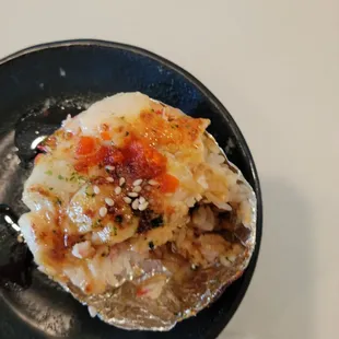 a half eaten sushi on a black plate