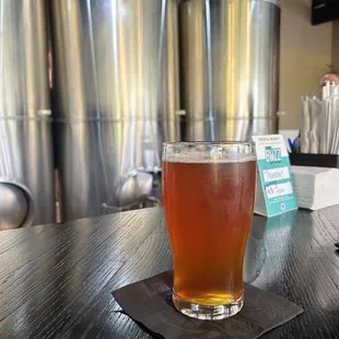 a pint of beer on a bar