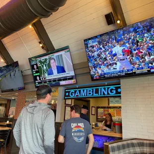 Huge TVs near the pull tab booth